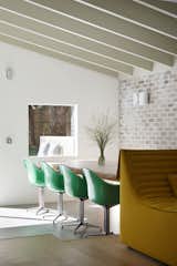 The dining area features Apple Green DAX chairs by Charles and Ray Eames for Herman Miller.