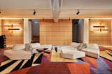 Another lounge area is located in the sound-proof basement, providing a spot to enjoy the custom stereo system. "The rug truly captures the ’80s love of geometric shapes," says Lorenz.