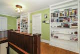 Several bookcases frame the staircase landing upstairs.