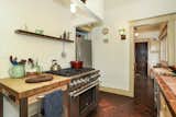 The cozy space also offers extensive cabinetry in a large pantry to the left.