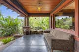 A porch stretches across the front facade, creating a shady spot from which to view the garden.