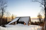 Cabin A by Bourgeois / Lechasseur architectes is perched on a mountainside overlooking the Saint Lawrence River in Québec, Canada. The "A" in the name references the nautical alphabet of the International Code of Signals (ICS), while the home’s angular form was derived from the maritime Alfa signal flag and the shape of a ship’s sail facing the wind.