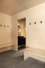 A small bathroom is tucked away near the mudroom, hidden behind a pocket door.
