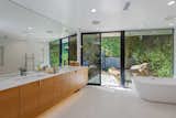 The master bath has an oversized tub and floor-to-ceiling windows overlooking the zen garden.