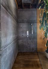 An oversized shower in one of the bathrooms is encased by a glass panel along one side.