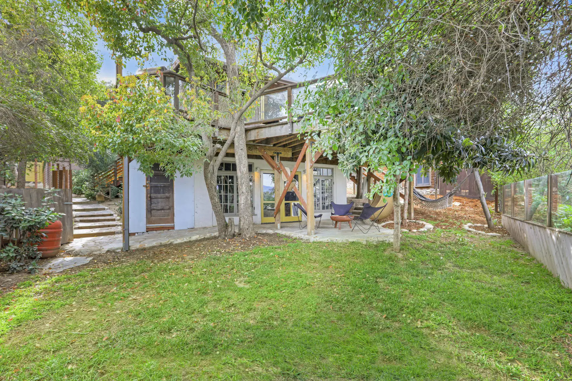 Measuring 6,428 square feet, the tree-encompassed lot presents a rare city sanctuary.
