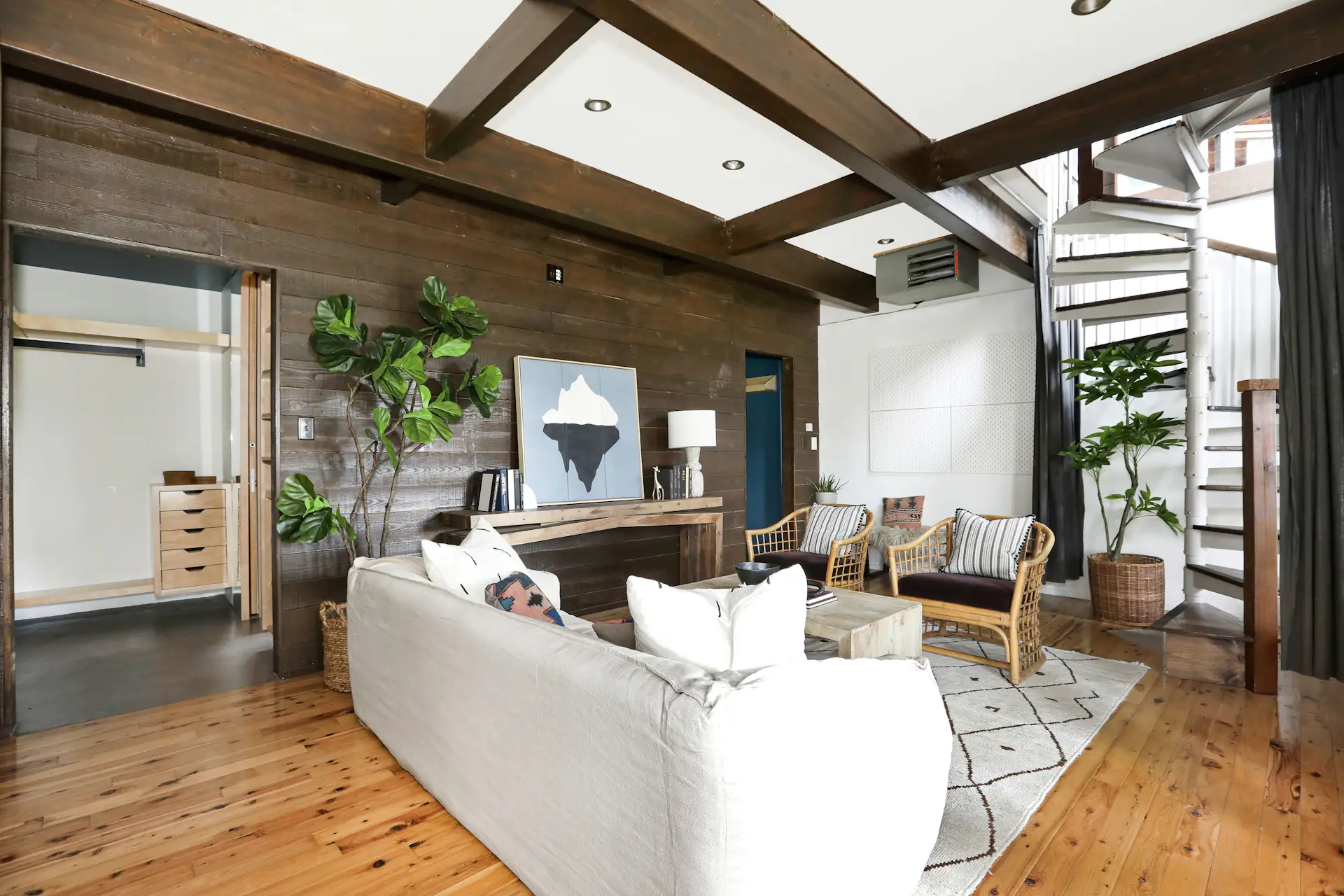 Box-beamed ceilings top the bonus area, reached by a spiral staircase from the living area.