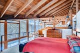 The master bedroom sits in a loft overlooking the living area and offers a wood stove.