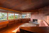 The home helped to establish Lautner’s name independent of his mentor, although Frank Lloyd Wright’s influence is evident throughout. Ribbon windows overlook treetops in the wood-clad living room, which also features a clay tile fireplace and an abundance of built-ins.