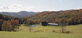 The property's location in a pastoral valley is surrounded by the Green Mountains of Vermont. A stream runs from the top of the valley to the pond, which is bordered by an old stone dam.