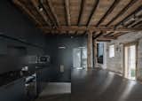 The firm also designed the new kitchen space, opting for a contrasting darker palette.