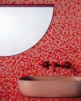 Bath Room, Tile Counter, Vessel Sink, and Mosaic Tile Wall “This bathroom was inspired by ’70s cult horror film Suspiria by Dario Argento,” says Cluroe. “Film is always an influence on our work, and the use of color in that film is so dramatic in quite a camp way. We wanted to tap into that and see if we could go there.” The pink sink is by Kast, and the retro red taps are by Fantini.  Photos from Put Lipstick on Your Door: 5 Ways to Make Your Home Unapologetically Bold