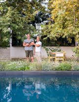 Guy (holding Pickles the cat) and Mark transformed the backyard, adding a pool and planting sycamore trees and native grasses. A custom dining table by Angel City Lumber is paired with vintage chairs from Amsterdam Modern.