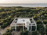 On a rustic strip of coastline near Puerto Escondido, Mexico, S-AR designed a beach getaway with an open concrete grid that frames its natural surroundings.