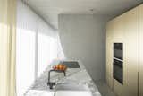The kitchen includes a KV1 faucet from Vola and a cooktop from Novy.