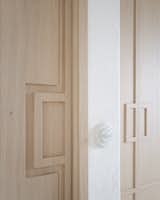 Geometric recessed door handles adorn solid oak pocket doors.