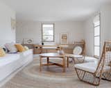 In the living area, a pair of rattan chairs found at the Paul Bert flea market in Paris join a coffee table designed by Guillerme et Chambron, also a flea-market find. A custom rug by CODIMAT was made in Madagascar.