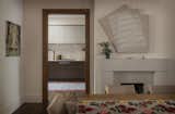 In the adjacent dining room, a dynamic painting by Johnny Abrams counterbalances a stolid limestone fireplace.  Photo 7 of 26 in A Pair of Filmmakers Give Their San Francisco Edwardian a Sensuous Edit