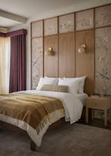 The younger daughter’s room is small, but gem-like in its design. A custom wood frame behind the bed frames hand-painted wallpaper in De Gournay’s Badminton pattern.  Photo 20 of 26 in A Pair of Filmmakers Give Their San Francisco Edwardian a Sensuous Edit