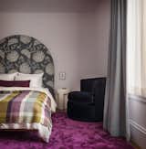 The homeowners made sure that their daughters had a say in designing their rooms. “Their parents were so inclusive of their goals and preferences,” says Geremia. “They were sensitive to their kids, wanting them to be part of this home and feel engaged.” The older daughter’s bedroom features a bold, magenta silk rug and a custom headboard.  Photo 19 of 26 in A Pair of Filmmakers Give Their San Francisco Edwardian a Sensuous Edit