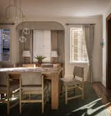 The traditional window treatments lend an unobtrusive elegance to the dining room. The couple were initially unsure about keeping the home’s dark wood floors, but wanted to keep the interior as warm as possible. “We found a good equilibrium by opening up the house, letting in more light, and opening the space from the dining room—gestures in the loft direction that preserved the differentiation of spaces in the house,” says the husband.  Photo 10 of 26 in A Pair of Filmmakers Give Their San Francisco Edwardian a Sensuous Edit