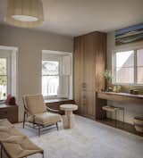 Custom millwork and shutters complement the original, leaded-glass windows. “We had been to the Getty Museum looking at some amazing wooden shutters there,” says the husband of the inspiration. A large silk Niba Designs rug provides a serene backdrop for the space.