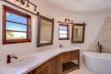 The modernized master bathroom includes a new double vanity, a large soaking tub, and an oversized shower.