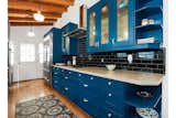 Another view of the kitchen. Black subway tile contrasts with the blue cabinetry.