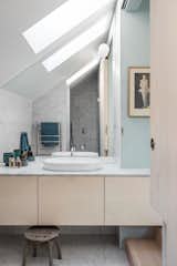 A peek into the bathroom, which is dressed in marble and bathed in natural light from skylights.