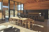 Inside, clear-coated cedar dominates the walls and ceilings, seamlessly extending along deep exterior overhangs as well. Continuously running floors and full-height windows also enhance the home’s connection with the outdoors.