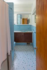 A look at the original baby blue bathroom—one of two full bathrooms in the home.