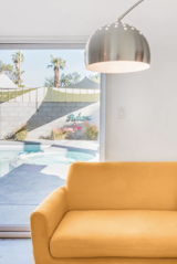 Enter through the turquoise door into a white-walled home brought to life through the smart use of color. The three bedroom, two bathroom ranch-style home has a pool and adequate outdoor seating area for ample guests. Above the pool, as an instruction and a way of life in Palm Springs, rests the word ‘relax.’  