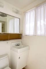 Another of the bathrooms features original cabinetry and fixtures.
