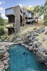 A waterfall trickles down the hillside to meet a pool at the base of the lot. Rocks surrounding the pool were brought in from nearby Healdsburg, California.