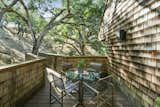 A private deck is accessible from the kitchen, with a small section extending to meet one of the many oak trees that stud the hillside.