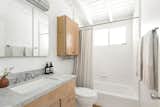 The renovated bathroom includes marble countertops.