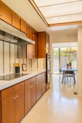 An opposite view of the kitchen looking toward the dining area.  Photo 6 of 16 in A Restored Post-and-Beam by a Richard Neutra Protégé Lists for $700K