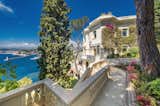 Outdoor, Side Yard, Trees, Shrubs, Flowers, and Large Patio, Porch, Deck Positioned in a prime location, the estate—which is still referred to locally as "Sean Connery's home"—is perched above Port de Nice and sits just 30 minutes from Monaco.  Photo 9 of 11 in Scottish Actor Sean Connery’s Former Seaside Villa Looks Like the Perfect Place to Quarantine