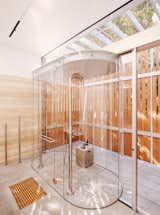 Screened by a slatted wood wall, the see-through shower in the master bathroom straddles indoors and out. The 69 Shower column in by JEE-O.