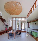 Dining, Chair, Ceiling, Pendant, Medium Hardwood, Bar, Table, Rug, Dark Hardwood, and Stools  Dining Ceiling Stools Medium Hardwood Photos from Vegetation Cocoons This Tranquil Beach House in Australia