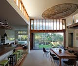 Dining Room, Rug Floor, Chair, Bar, Ceiling Lighting, Table, Dark Hardwood Floor, and Stools  Photos from Vegetation Cocoons This Tranquil Beach House in Australia