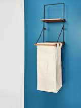 With a wall-mounted drying rack and laundry bag holder (shown), this system from Pottery Barn helps organize cleaning and then folds out of the way—perfect for small spaces or neat freaks.&nbsp;