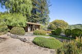 A closer look at the exterior of the guest house, featuring a striking backdrop of Tilden Park.  Photo 21 of 21 in An Impeccable Midcentury Compound in the Berkeley Hills Wants $3.4M