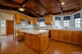 A look at the original kitchen reveals a mix of wood tones in the cabinetry and ceiling.