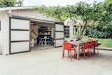 In the backyard, a detached building is currently used as a workspace but could be converted back into a garage. A large cement patio provides space for entertaining.