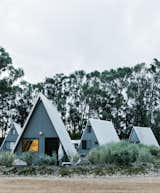 Exterior, Small Home, Metal, A-Frame, Wood, and Cabin  Exterior Metal Small Home Cabin Wood Photos from A Cluster of A-Frames Hugs White Sand Dunes on Australia’s Southwestern Coast