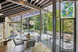 The dining area is surrounded on two sides by floor-to-ceiling glass. Several doors lead out to a large deck.  Photo 5 of 15 in A John Lautner Post-and-Beam Hits the Market for the First Time Ever