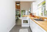 A look at the sun-lit kitchen with butcher-block countertops.