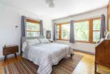 Expansive windows continue into one of the sunny bedrooms.