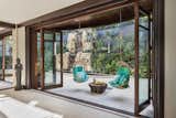 Behind the dining room table, another set of multi-paneled folding glass doors open to the backyard Zen garden—complete with a reflecting pool and waterfall.